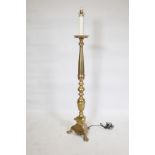A polished brass floor lamp, 53" high