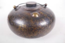 A Chinese brass hot water bottle with polished decoration through the bronzed patination, 4