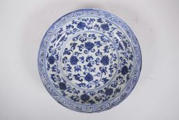 A Chinese Ming style blue and white porcelain dish with scrolling lotus flower decoration, 11½"