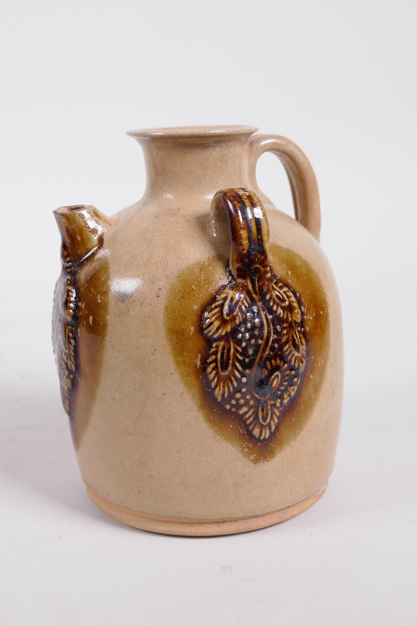 A Chinese ochre ground Changsha kiln pottery wine pourer with raised and glazed vine decoration - Image 2 of 5