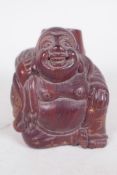 A Japanese carved hardwood figure of a traveller with large sack and tree stump on his back, 2½"