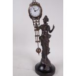A bronze mystery clock cast as an Art Nouveau style lady with the clock raised on one arm, 13" high
