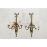 A pair of brass three branch wall sconces, with floral and scroll decoration, 27" high