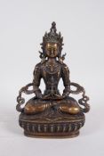 A Sino-Tibetan bronze of Buddha seated on a lotus throne, 8½" high