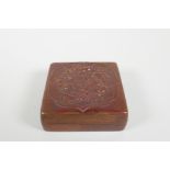 A Chinese pressed and patinated copper trinket box with raised mythical creature decoration,