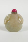 A Chinese celadon jade snuff bottle with two carved kylin handles, 2½" high