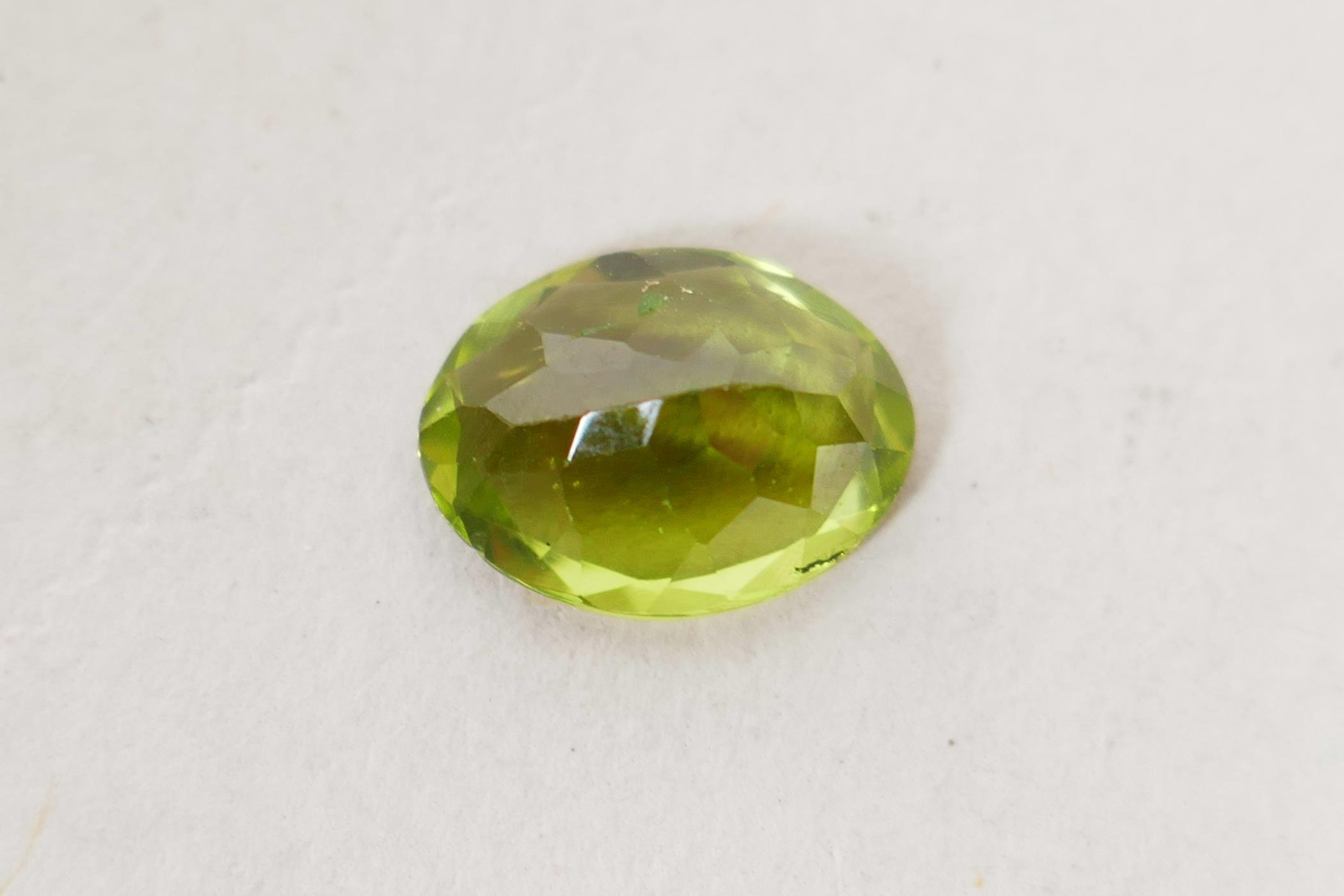 A 1.99ct peridot, oval mixed cut, ITLGR certified, with certificate - Image 7 of 8