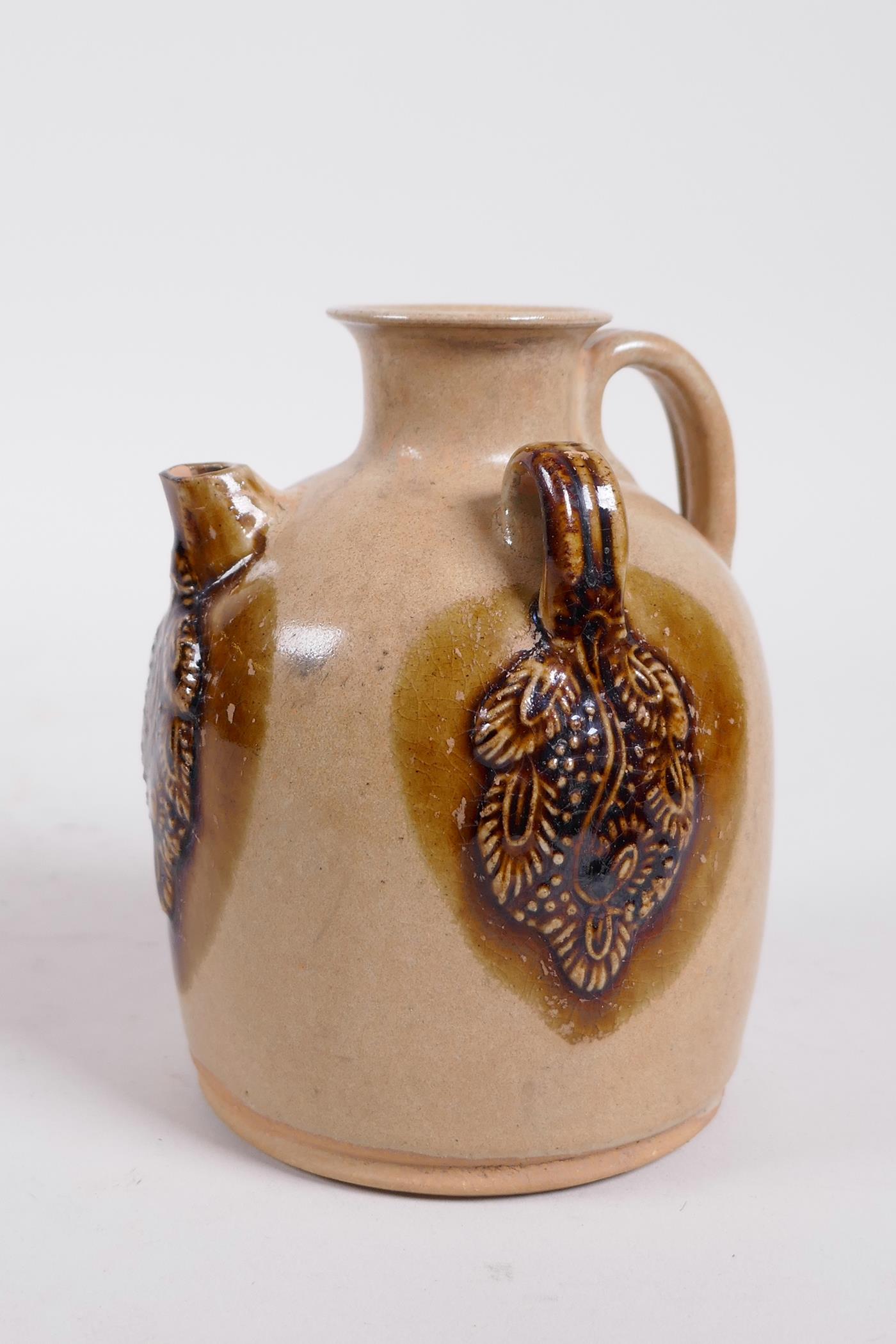 A Chinese ochre ground Changsha kiln pottery wine pourer with raised and glazed vine decoration - Image 3 of 5