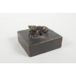 A Chinese bronze seal decorated with a water buffalo knop, 2" x 2"
