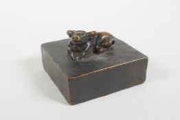 A Chinese bronze seal decorated with a water buffalo knop, 2" x 2"