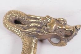 A Chinese brass walking stick handle cast as a dragon, 5" wide