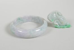 A Chinese mottled green and grey jade bangle, together with a jade pendant carved in the form of