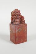 A Chinese red soapstone seal with a carved kylin knop, 3" high