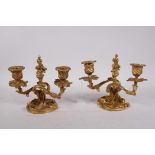 A pair of gilt brass two branch rococo style dwarf candlesticks, 6" high