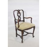 A late C19th/early C20th walnut cello chair, with carved and pierced back and shaped arms, raised on