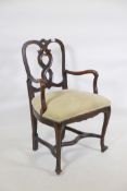 A late C19th/early C20th walnut cello chair, with carved and pierced back and shaped arms, raised on