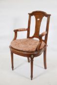 A C19th Continental beechwood open armchair with burr walnut splat back and ormolu mounts, raised on