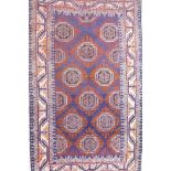A blue ground Middle Eastern wool rug with a Bokhara style design, 41" x 72"