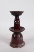 A C19th Chinese treacle glazed terracotta candlestick, 7" high, A/F