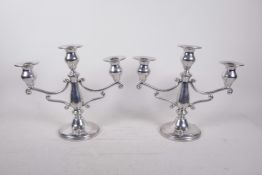 A pair of three branch pewter candelabra, 9½" high