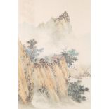 A Chinese watercolour on silk depicting a mountain landscape with a hidden dwelling, signed and seal