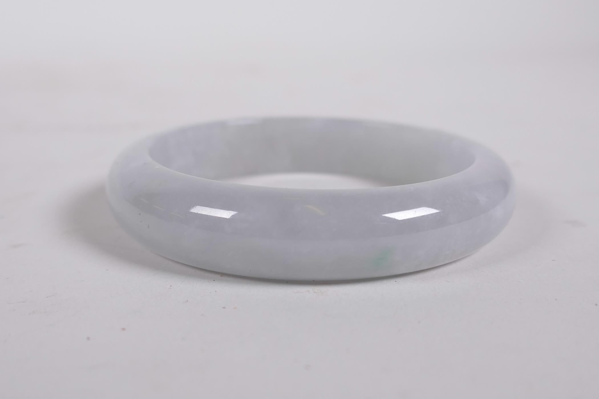 A grey/celadon jade bangle, 3" diameter