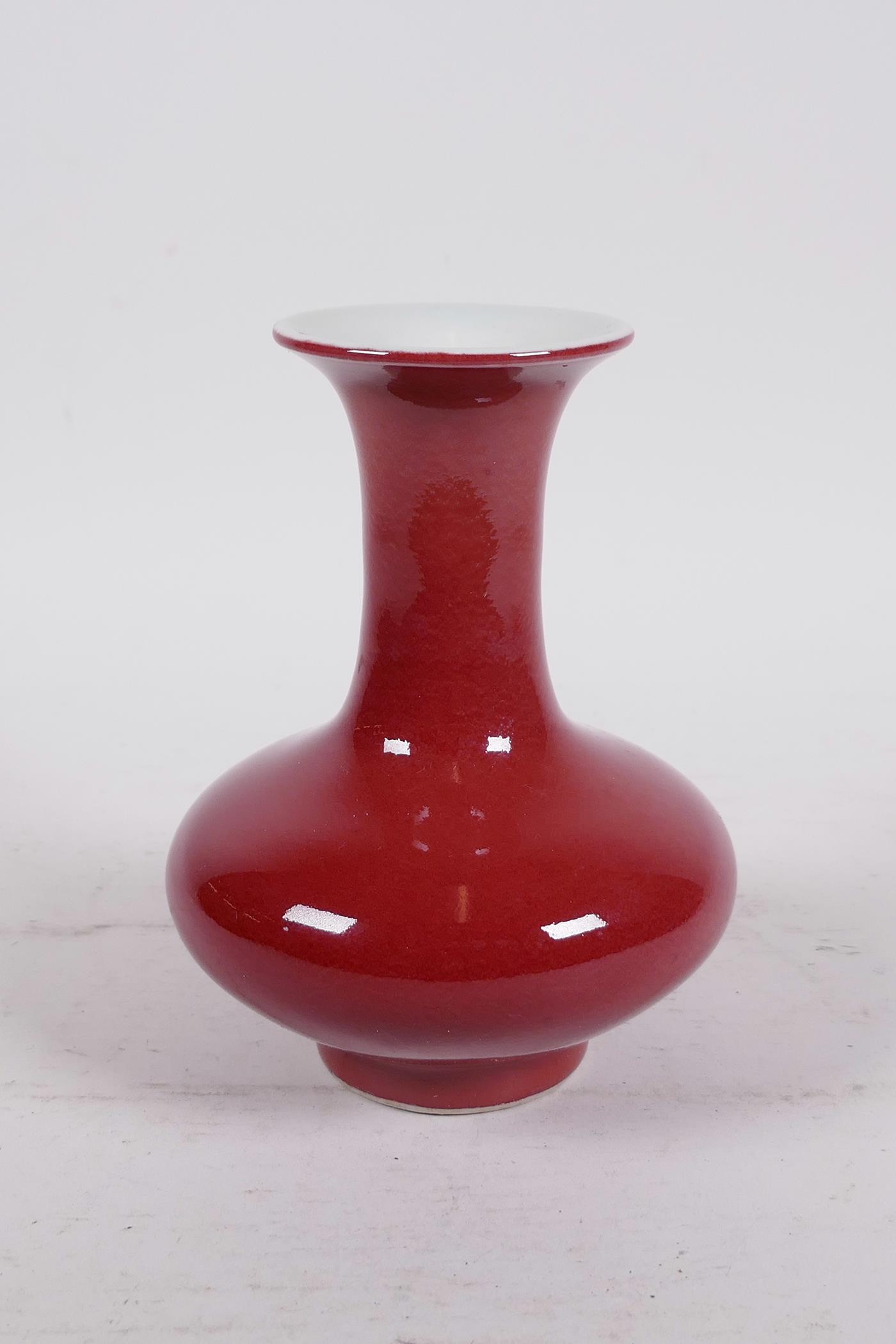 A Chinese sang de boeuf glazed porcelain vase of squat form with a flared rim, 5½" high - Image 2 of 3