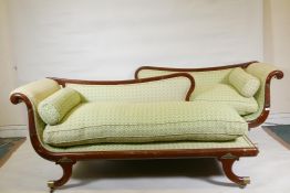 A pair of Empire style mahogany framed chaise longues, with brass mounts and castors, 68" x 25" x