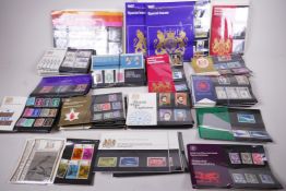 Over 85 sets of British Post Office mint stamps in their original cellophane presentation packs,