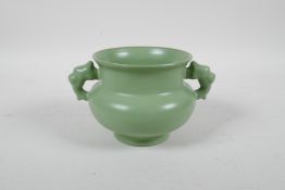 A Chinese green glazed porcelain two handled censer, raised character inscription to base, 4½"