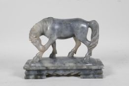 A Chinese carved soapstone figure of a horse, 6½" long, 5" high