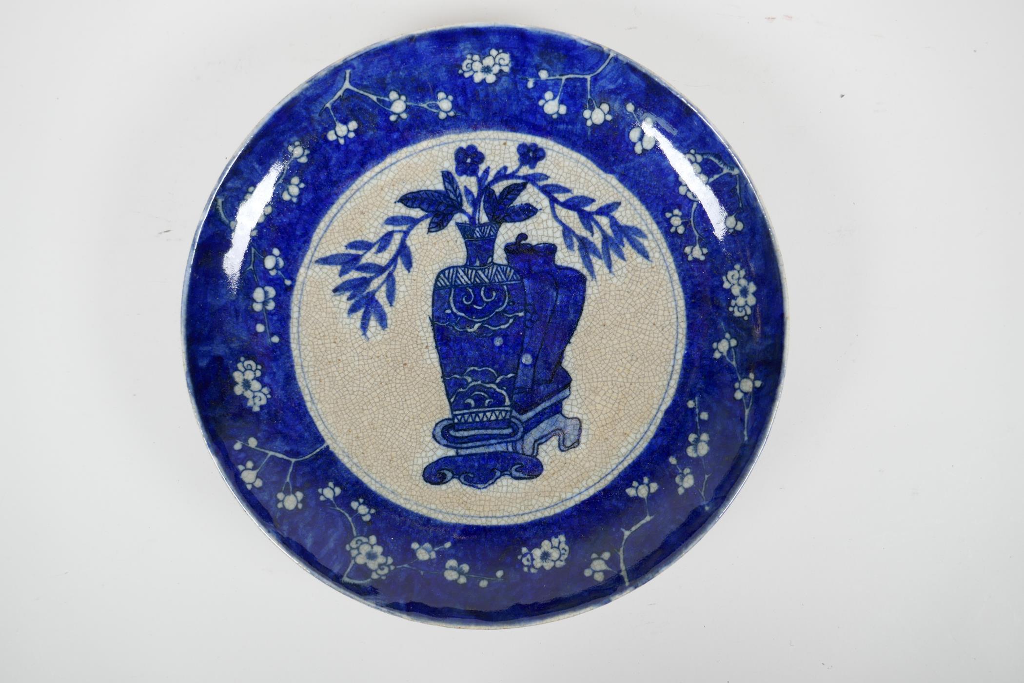 A Chinese early C20th blue and white crackleware charger decorated with objects of virtu within a