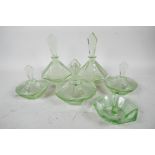 An Art Deco green glass dressing table set of octagonal form comprising two perfume bottles, three