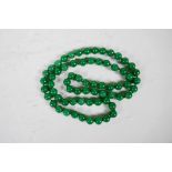 A string of green jade beads, 38" long