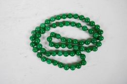 A string of green jade beads, 38" long