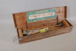 A vintage croquet set by John Jaques of London, complete with four mallets, hoop pegs, balls and