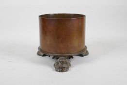 A Trench Art cylinder vase raised on tripod scrolled feet, 6" high, 6" diameter