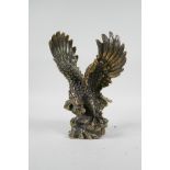 An Oriental filled bronze of an eagle, impressed mark to base, 8" high