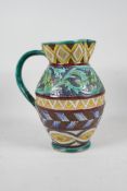 A majolica water jug with scrolling leaf and sunflower decoration, 10" high
