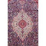 A rich blue ground full pile Kashan rug with a traditional floral medallion pattern, 94" x 63"