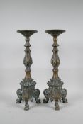 A pair of C19th brass pricket candlesticks converted for electricity, raised on tripod feet, 15"