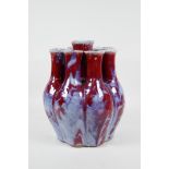 A Chinese flambe glazed porcelain nine section tulip vase, 9½" high