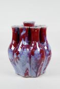 A Chinese flambe glazed porcelain nine section tulip vase, 9½" high