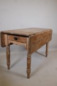 A C19th pine drop leaf table, with single end drawer, raised on turned supports, 47" x 21" x 30"