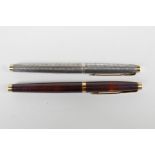 A sterling silver cased Parker 75 and another with a lacquer case, both with 14ct nibs, 5" long