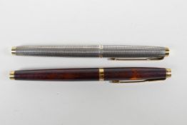 A sterling silver cased Parker 75 and another with a lacquer case, both with 14ct nibs, 5" long