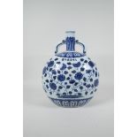 A Chinese Ming style blue and white porcelain two handled moon flask with floral decoration, 6