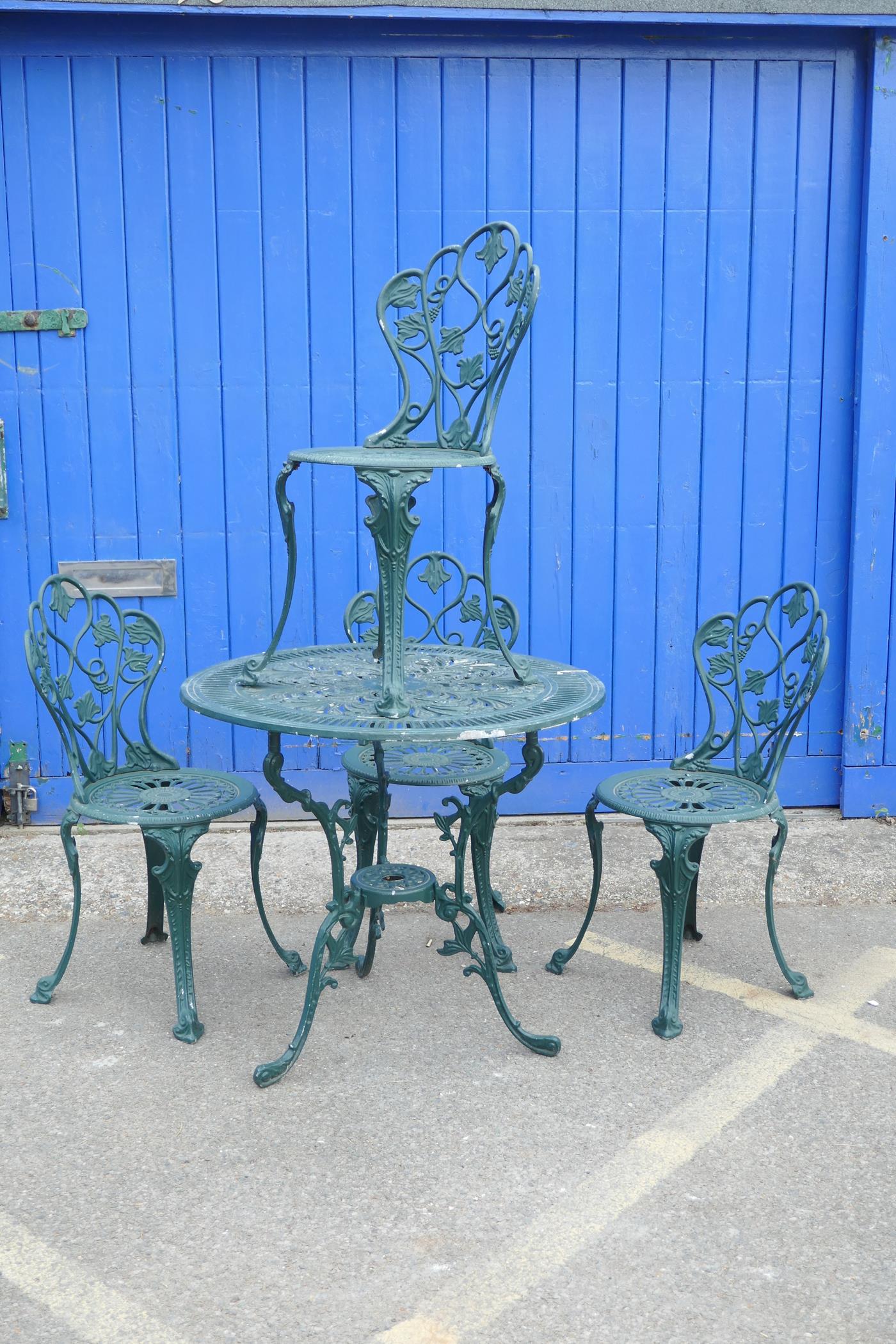 A cast aluminium garden table and chairs, the circular table with pierced decoration and three leg - Image 2 of 3