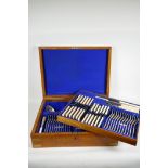 An oak cased canteen containing a twelve place silver plated dinner service, stamped Maple London,