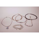 A silver and amethyst set necklace, a silver and crystal pendant choker and three other silver